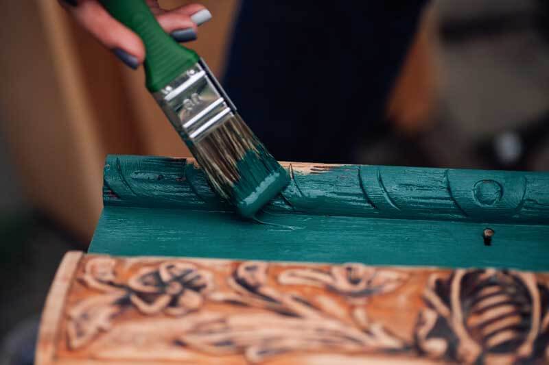 Macro,On,A,Brush,In,Paint,And,The,Process,Of macro on a brush in paint and the process of refreshing an old box with monograms, restoring antique objects and moderate consumption.